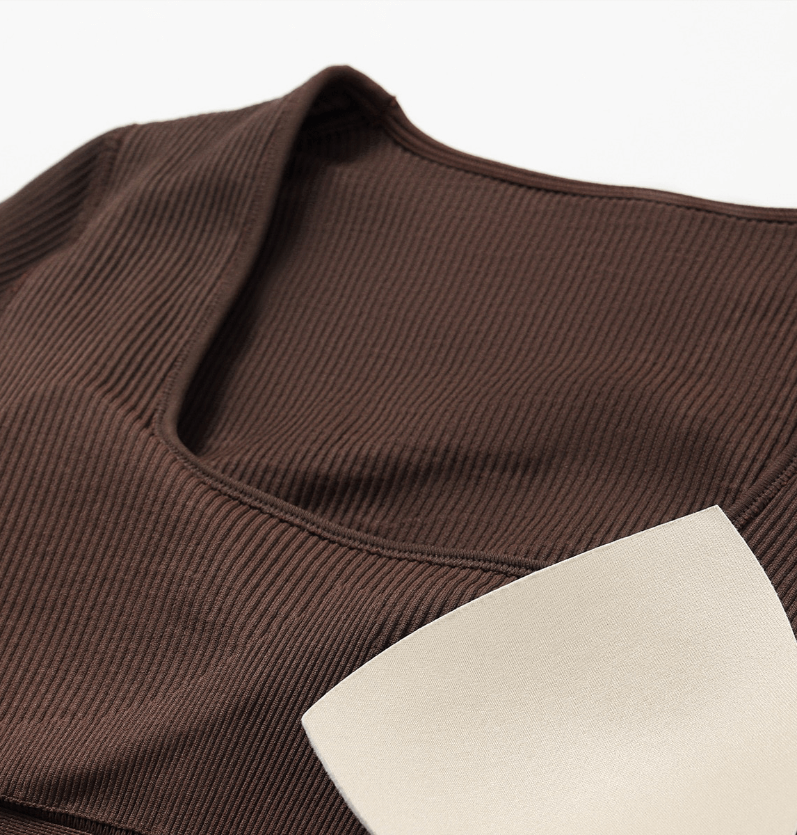 Close-up of brown seamless yoga suit with ribbed texture and thumb holes, designed for women's fitness and comfort. Model SF1287.